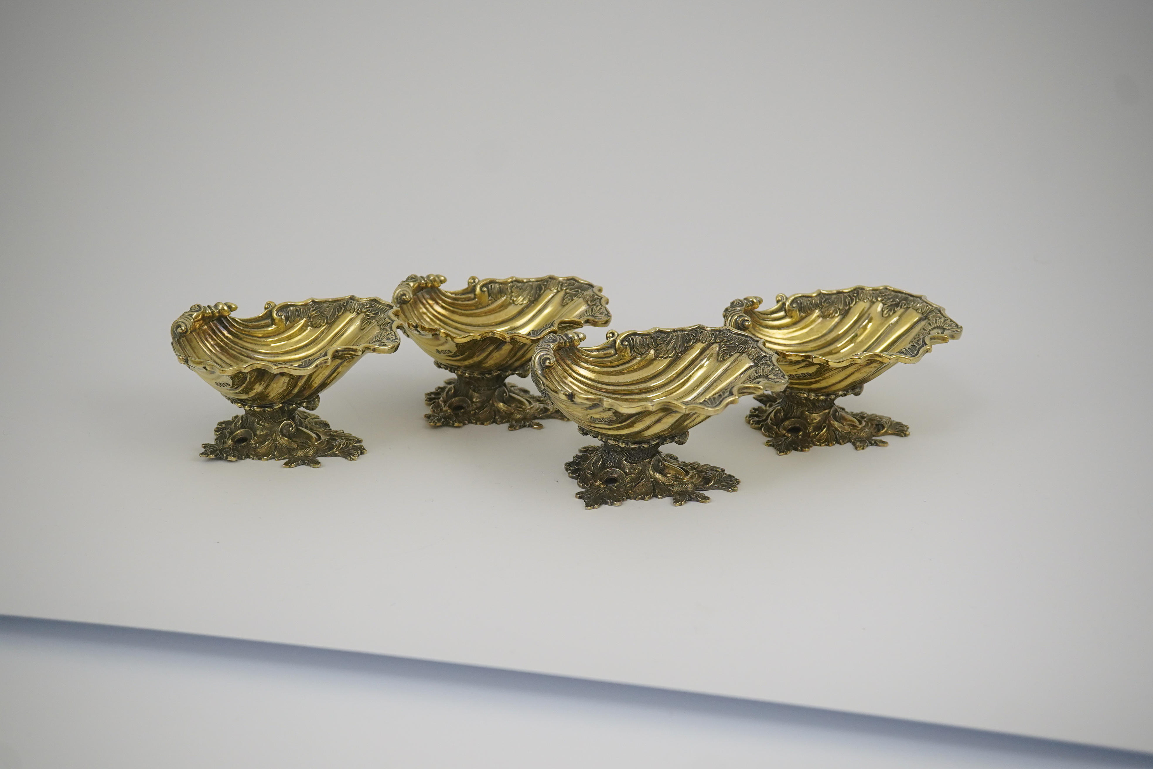 A set of Elizabeth II Victorian style silver gilt pedestal shell salts, by Asprey & Co Ltd